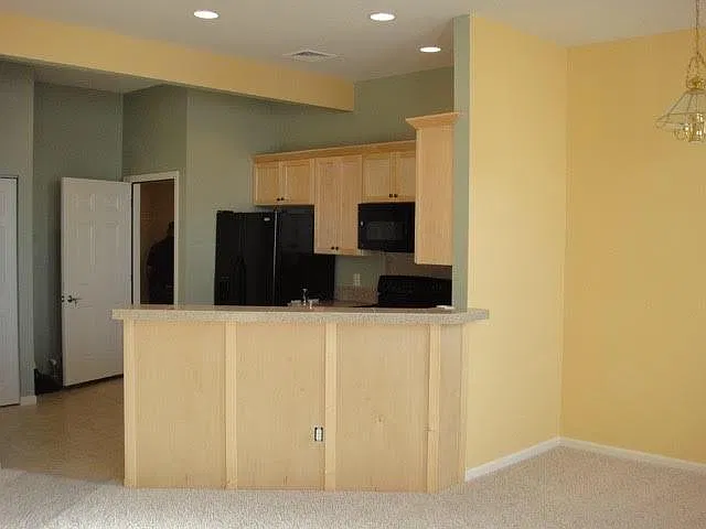 This is the view of the entrance door opening to the kitchen-facing the living and dining areas.