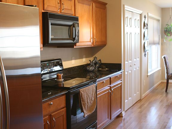 Kitchen with stainless steel and black appliances and new granite counter tops
