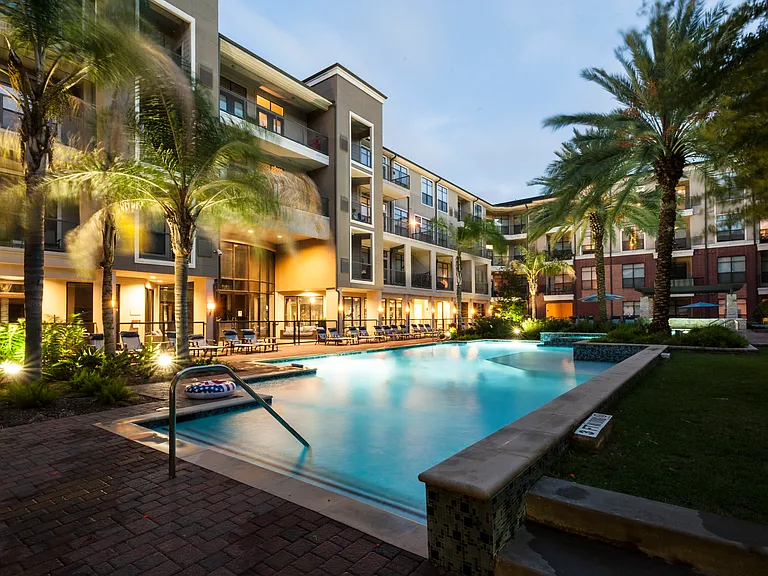 Resort-Inspired Pool with Sun Ledge, Lap Pool, and Waterfall.