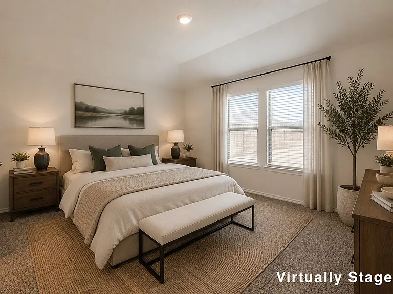 Step into luxury in this beautiful primary bedroom with beautiful views of the backyard.