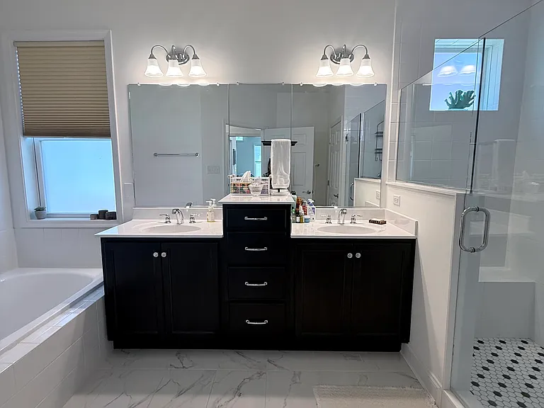 Stunning primary bathroom with double sink, tons of storage and a separate soaker tub / stand up shower