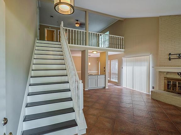 Grand staircase and open Living Room.