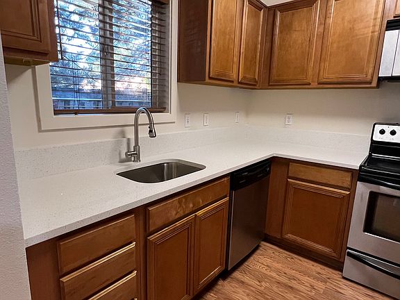 Kitchen with new quartz countertops, undermount stainless steel sink, and stainless steel appliances