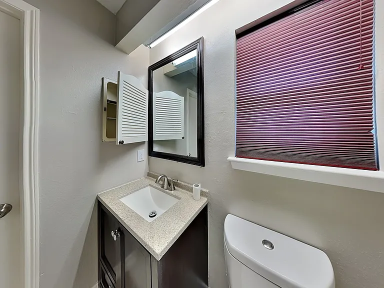 This cozy bathroom features a