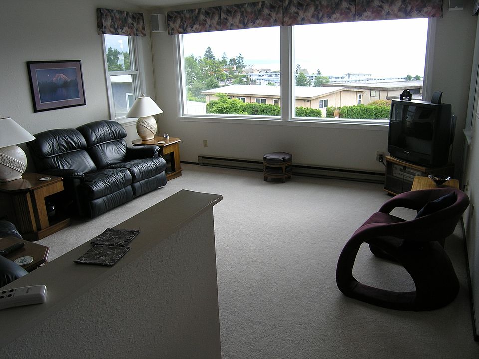 Sunken living room with picture windows and tall vaulted cei