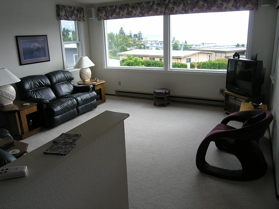Sunken living room with picture windows and tall vaulted cei