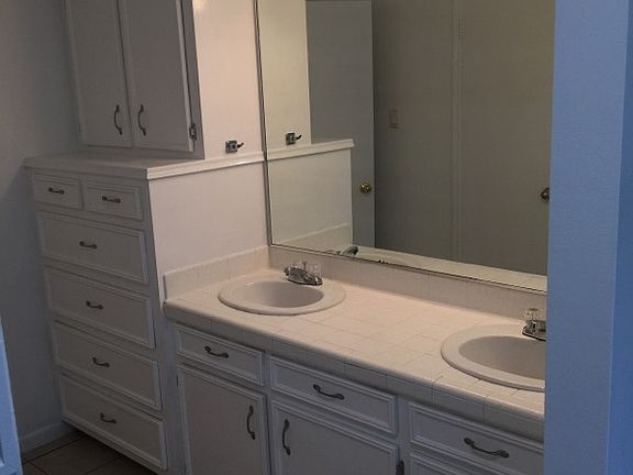 large master bath with lovely built-in solid wood cabinetry.