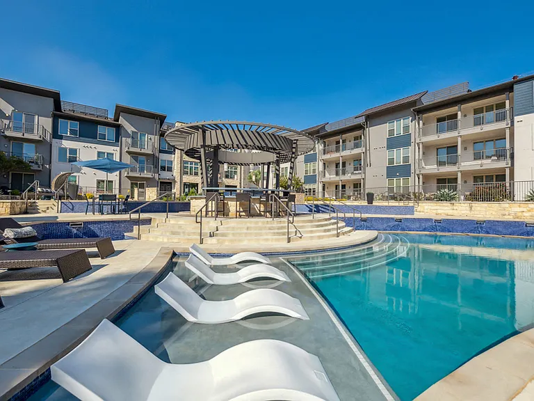 Resort-style pool with tanning shelf