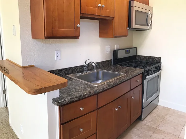 Full kitchen.
Tile and carpet has been replaced with new wood plank flooring throughout.