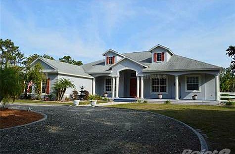 This beautiful estate is nestled in the heart of six gorgeous acres of pasture, pine, and towering o