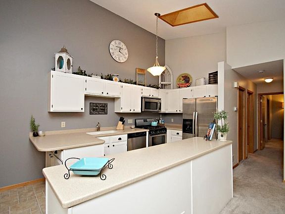 Center island for extra storage, neutral decor throughout.