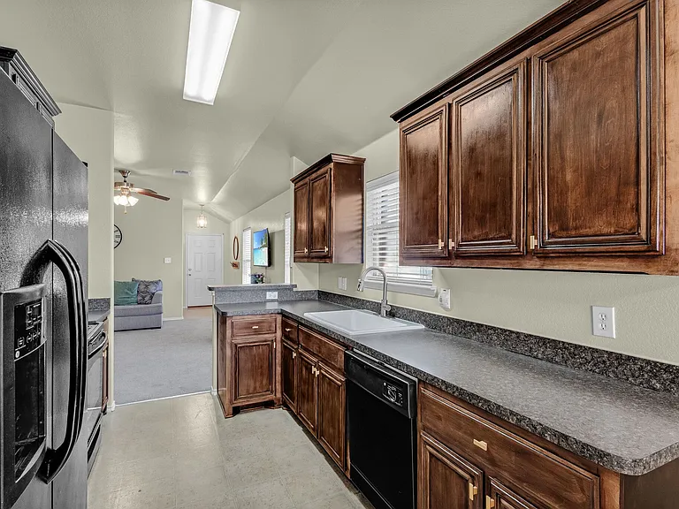 View of the kitchen showing refinished kitchen cabinets with elegant hardware