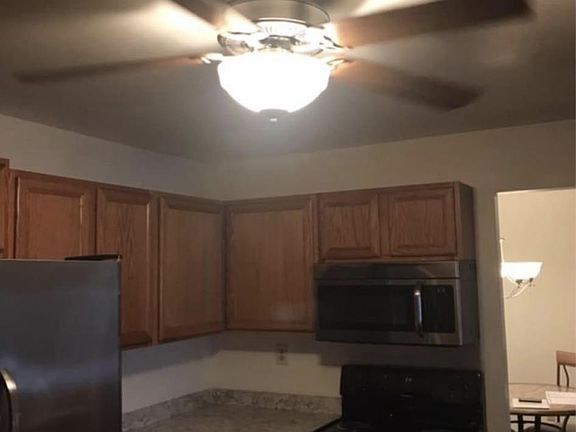 Kitchen with dishwasher, microwave, Oven, refrigerator, and garbage disposal.