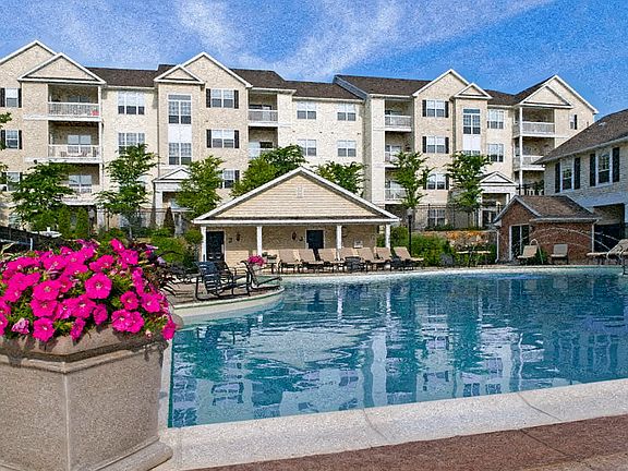 Expansive resort-style heated swimming pool with fountain and sundeck