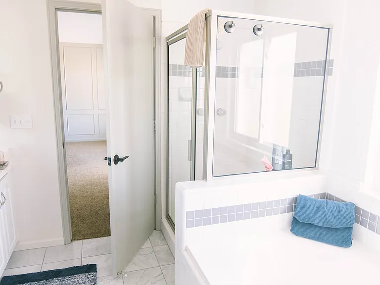 master bath with double sinks, large soaking tub, and shower