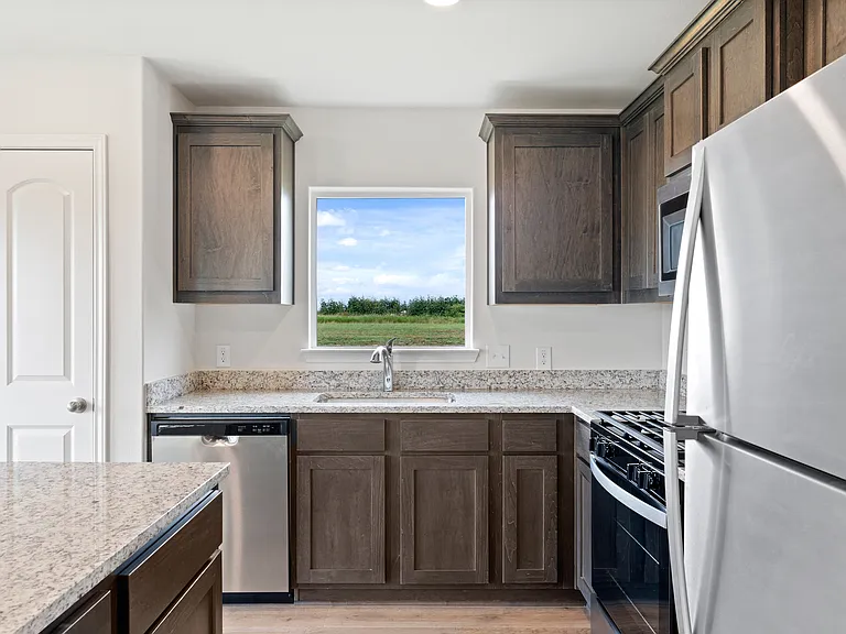 The kitchen has gorgeous wood cabinetry.