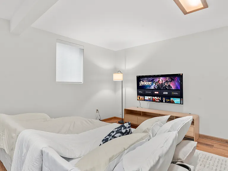 Flexible basement bedroom/lounge with a convertible sofa for comfortable seating or sleeping with pool table.