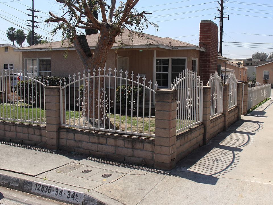 House street view. Fenced front and side yard.