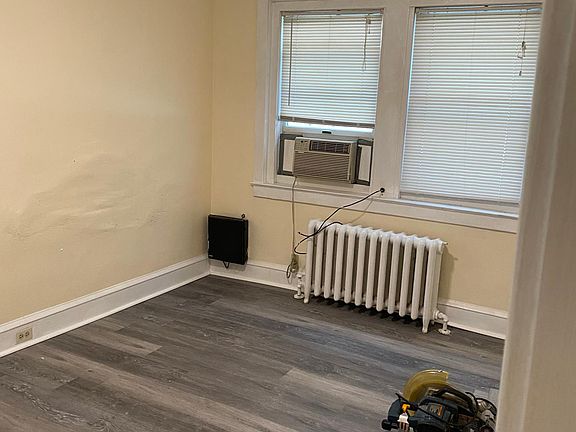 Living room right off of the kitchen. New floor new trim new paint new light fixture.