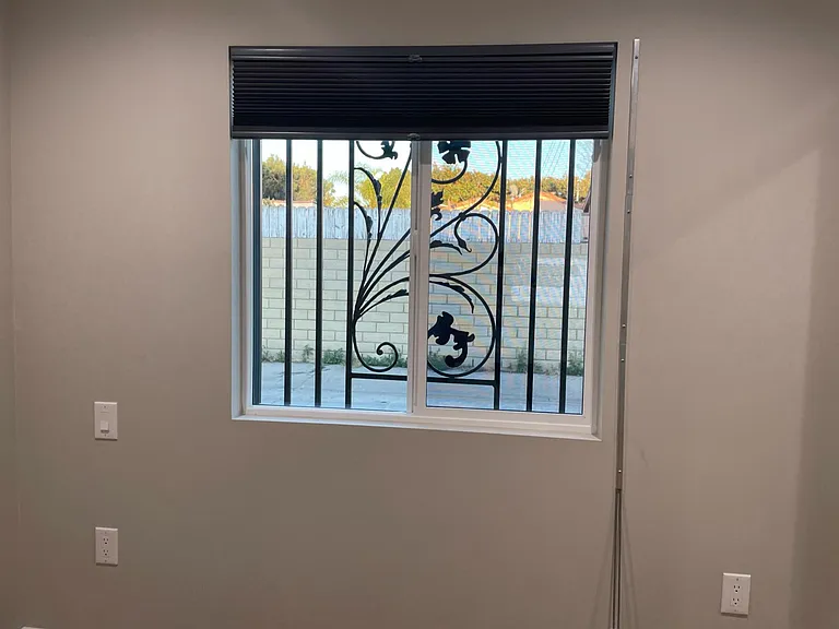 Bedroom window with security bars with emergency escape.