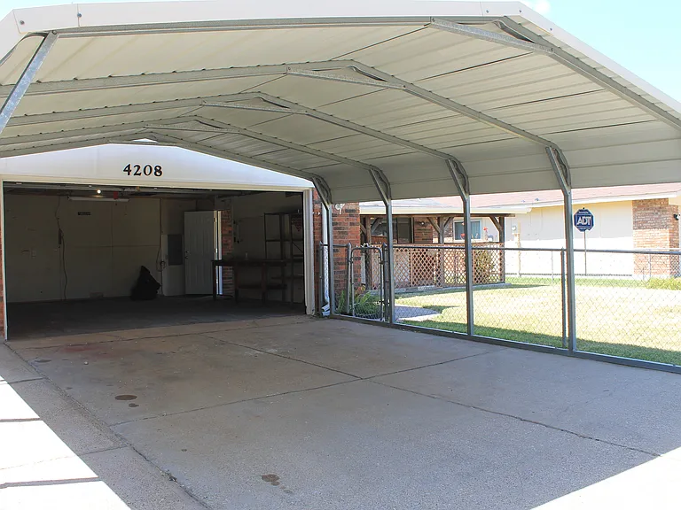 Bonus to the property- a covered carport provides convenient shade and protection for additional vehicles.