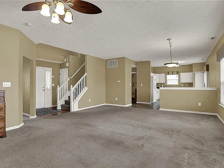 The living room carpet floor has been replaced to light grey hardwood.