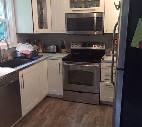 Kitchen with Ikea cabinets all utensils, dishes, glasses, pots and pans