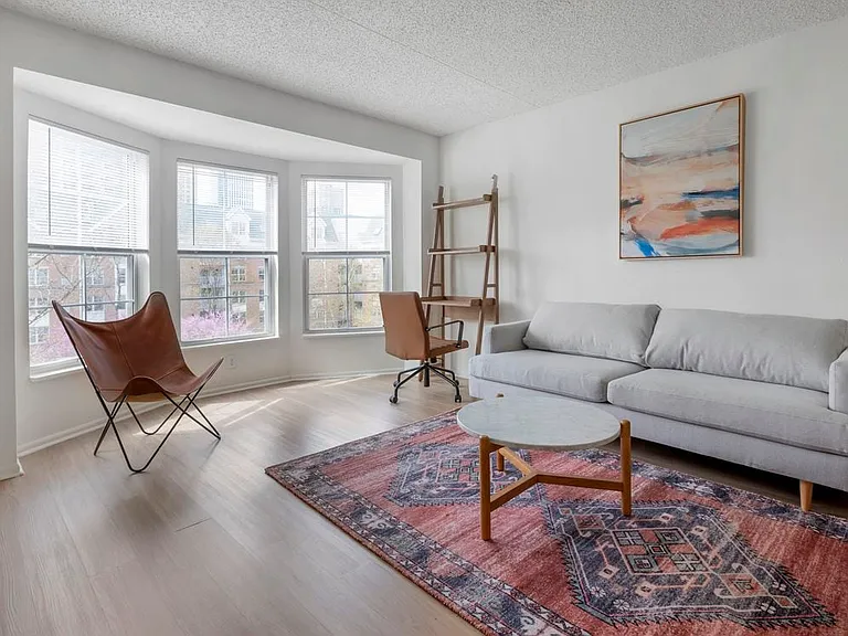 Furnished+ apartment homes come outfitted with a sofa, side chair, side table, coffee table, office chair, desk, TV stand and 50" Television (Representative Image exact items and style of furnishings may vary)