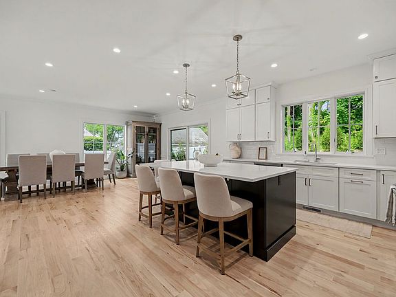 A thoughtfully designed 4,000 square-foot coastal layout unfolds with sun filled, open concept living spaces, seamless indoor/outdoor flow.