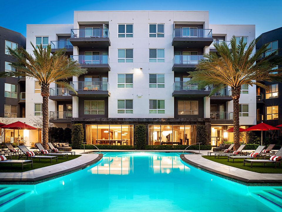a swimming pool in front of Vora Mission Valley Apartments at night