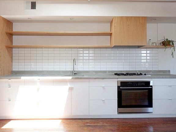 modern kitchen w/ open shelving, poured concrete counters, brand new appliances