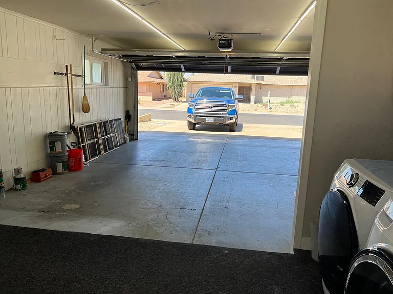 Garage features bright LED lighting strips that come on with motion.