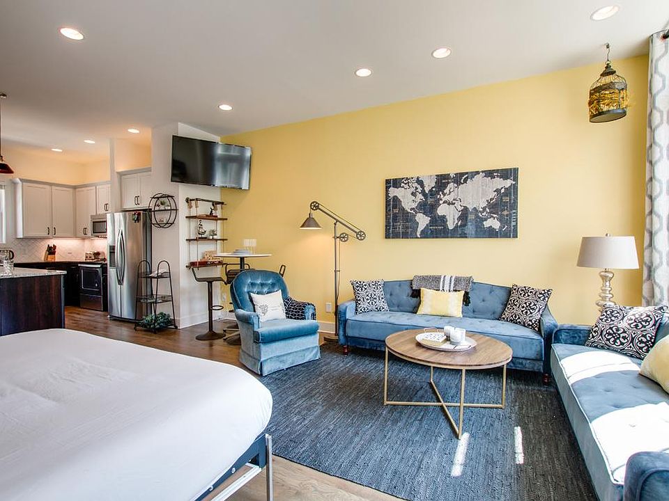 Welcome!! The open-layout here is a great central area for the home. Note: the king-size murphy bed at left flips up into the wall. It has a whiteboard base when it's stowed. Great for planning, grocery lists, home office work, etc.!