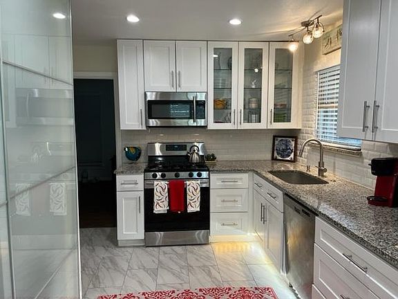 Remodeled kitchen - stainless steel appliances, white cabinets and lots of drawer storage.