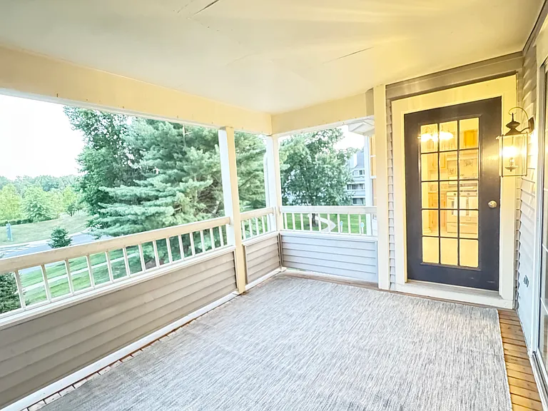 Large outdoor patio overlooks greenery and is refreshed with new lighting and carpeting