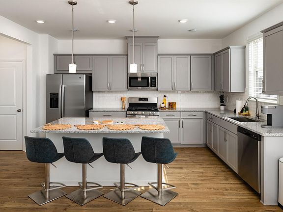 Another view of the spacious kitchen and stainless steel appliances