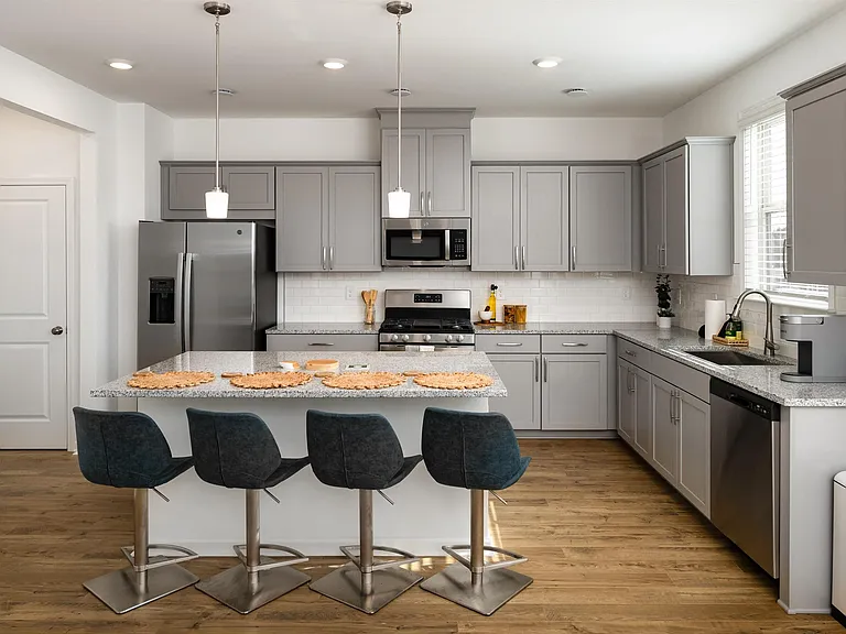 Another view of the spacious kitchen and stainless steel appliances