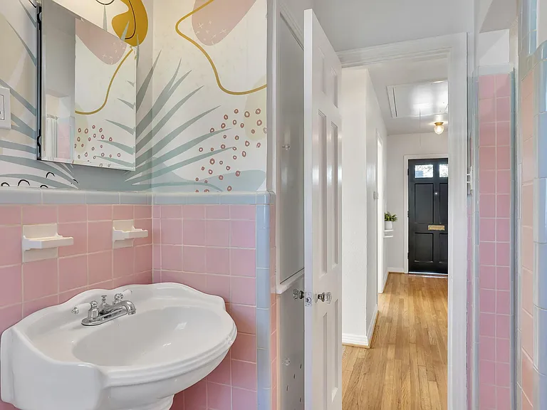 Original bathroom tile with pedestal sink and medicine cabinet.