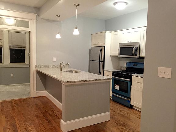 The kitchen includes room for stools to enjoy a meal.
