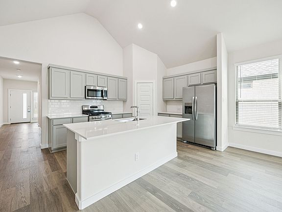 Kitchen in the Claret home plan by Trophy Signature Homes - REPRESENTATIVE PHOTO