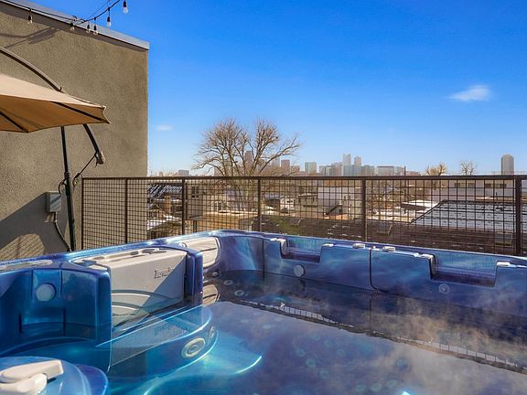 Soak in the relaxing HOT TUB with STUNNING DENVER SKYLINE VIEWS. Generously appointed outdoor patio and roofdeck furniture with 2 firepits, dining area, outdoor tower heaters, lounge chairs, a 6-person hot tub (with 96 jets!) and sun beds to name a few! E
