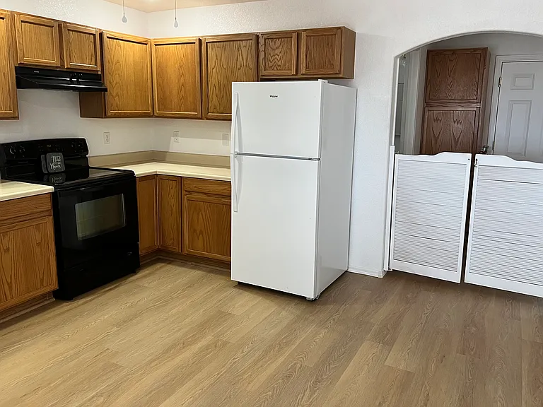 Kitchen with new refrigerator, saloon doors and extra storage.