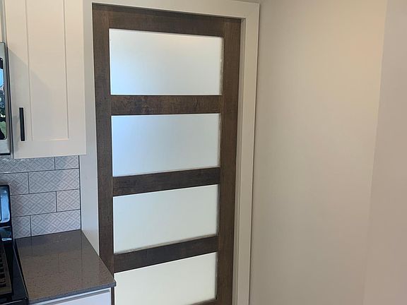 SLIDING GLASS POCKET DOOR FROM THE KITCHEN TO THE LAUNDRY ROOM.