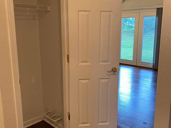 Hall closet and view to the living room