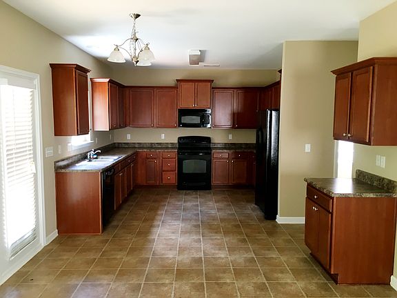 Den opens to kitchen (a Gourmet's delight)