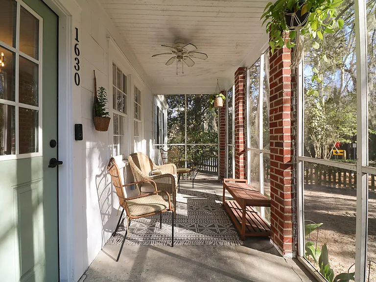 Screened in porch with outdoor seating for relaxed outdoor living