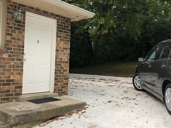 Apartment entry. Private backyard with parking and security lights behind apartment.