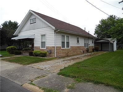 Side Exterior showing drive and carport.