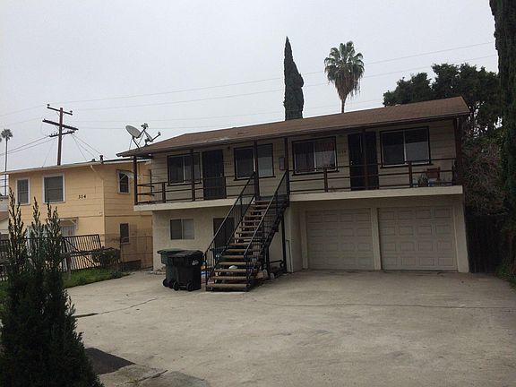 2 car parking in front of closed garages below unit