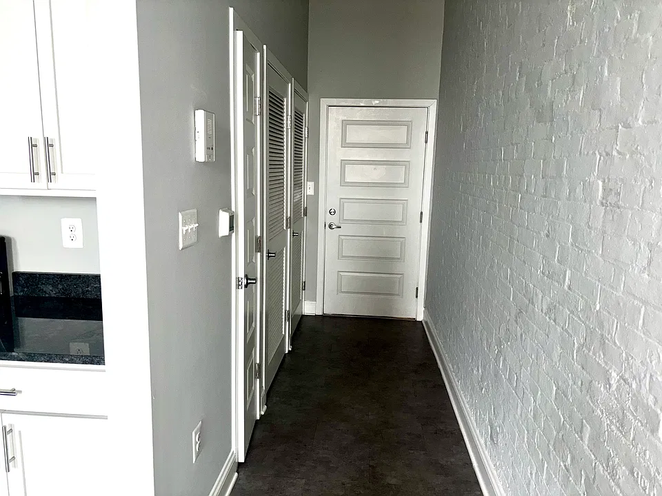 Front door hallway with washer dryer and utility closet